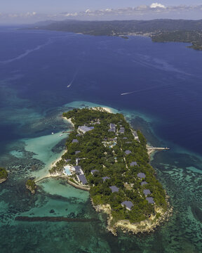 Aerial view of Cayo Levantado Beach surrounded by lush tropical vegetation, turquoise waters, and coral reefs in Samana, SAMANA, Dominican Republic.
