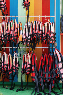 Row of Life Jackets Hanging on Display Rack