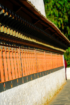 Changangkha Lhakhang, Traditional colorful prayer wheels in Buddhist mountain temple corridor