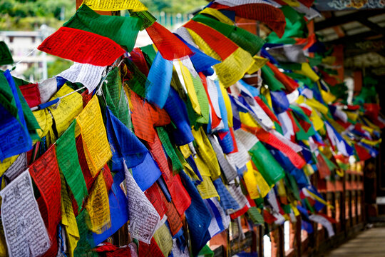 Changjiji Traditional Bridge, Colorful hanging fabric flags with prayer text in bright outdoor setting, Thimphu, Bhutan, SEP 2026