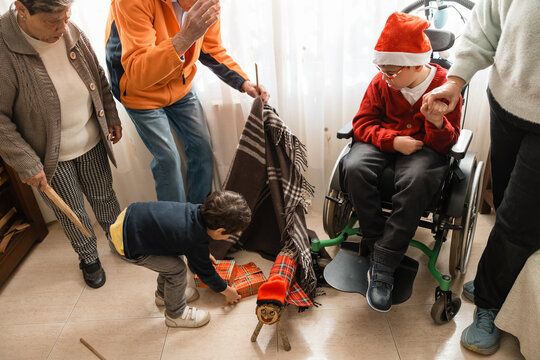 Family celebrating tio de nadal with child in wheelchair