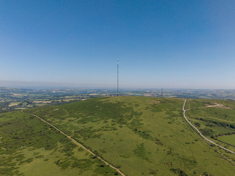 Aerial view of the Caradon Hill transmitting station mast standing on the grassy slopes of the moorland in Minions, Cornwall, United Kingdom.