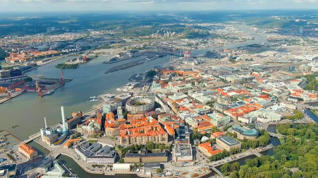 Gothenburg, Sweden. Aerial panorama over the Gota Alv river and Rosenlund Canal, historic red-roofed city center and industrial harbor under soft summer clouds. Drone footage, Point of interest