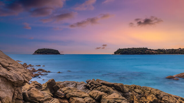 Long Exposure Seascape of Kata Beach with Rocky Shoreline and Tropical Forest, Phuket, Thailand