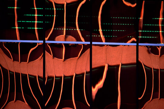 Abstract orange lines and green data display on black