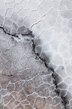 Abstract salt flat texture with cracked saline geology
