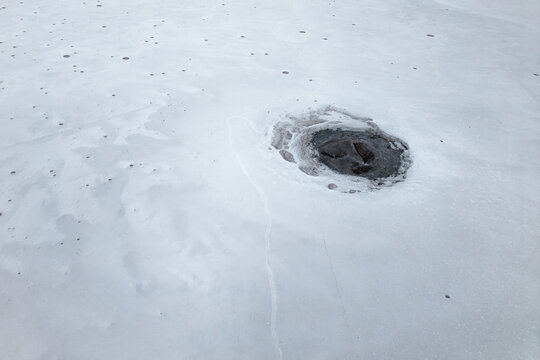 Natural salt flat texture with dark saline erosion hole