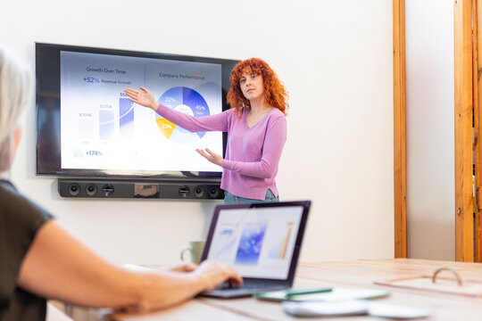 Young businesswoman present chart to colleague in office