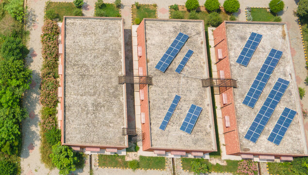 Lahore, Pakistan - 08 September 2026: Aerial view of a government office data canter complex featuring flat rooftops equipped with solar panels, surrounded by landscaped greenery and paved walkways.