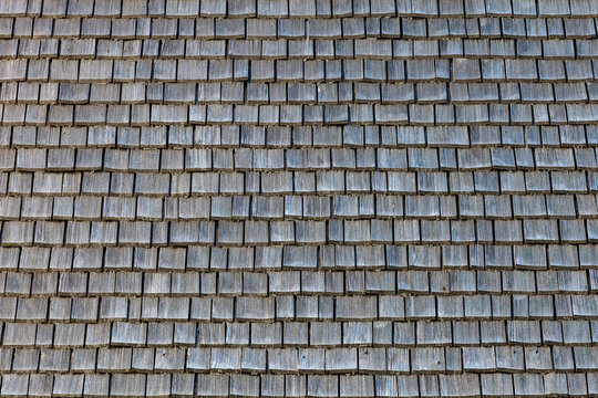 Rustic architecture and traditional roofing weathered wooden shingles texture on a mountain cabin roof for construction and heritage restoration projects