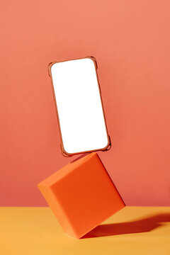 Levitation smartphone with blank screen and orange square block