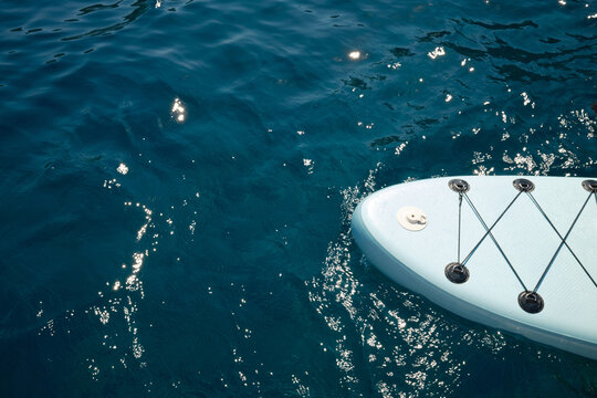 Paddleboard bow floating on clear blue ocean water