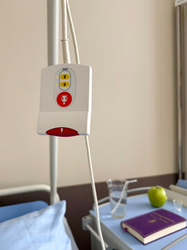 Nurse call button in hospital room beside patient bed