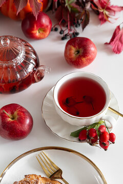 Autumnal Fruit Tea Served with Fresh Apples and Pastry on White Table