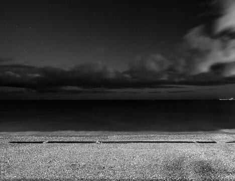 Night seascape over pebble beach in Nice, France
