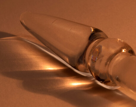 Glass bottle stopper macro with warm amber reflections