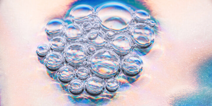 Macro view of iridescent bubble cluster in liquid