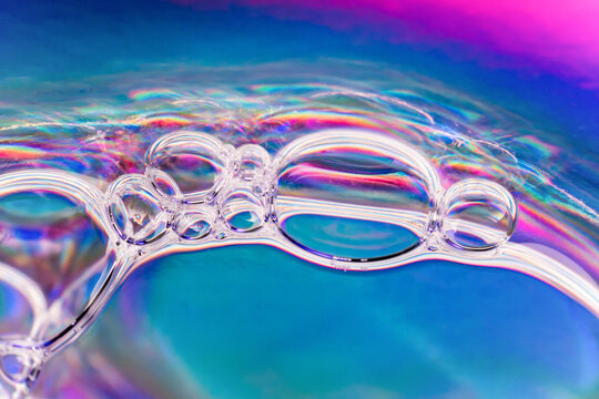 Macro view of soap bubbles with iridescent blue reflections