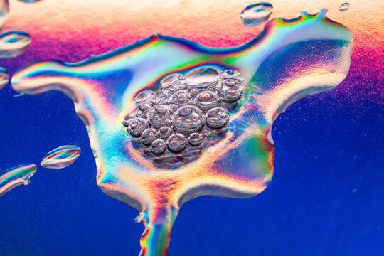 Macro view of iridescent liquid and air bubble cluster