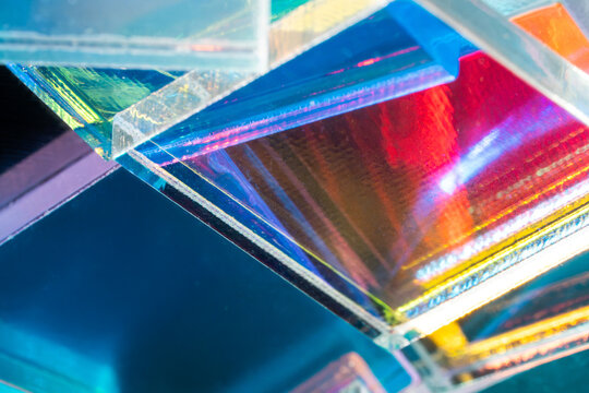 Iridescent glass prism with colorful tech background