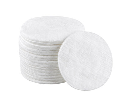 Stack of white round cotton pads with one leaning against the pile, isolated on a clean white background
