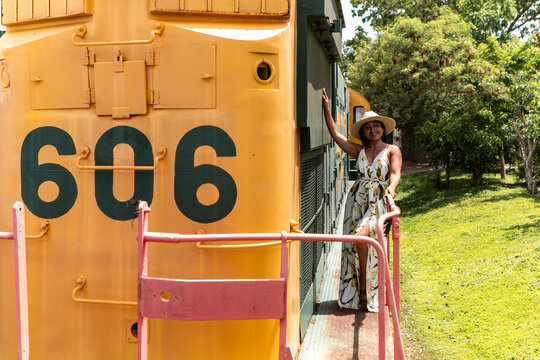 Mexican woman beside vintage train in Mexico