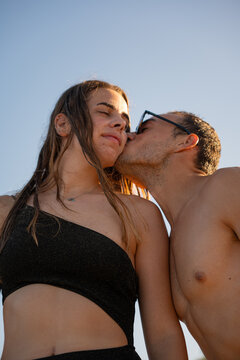 Young couple share an affectionate kiss at the beach