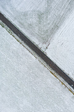 Snow-covered country road through fields in Trentham Victoria
