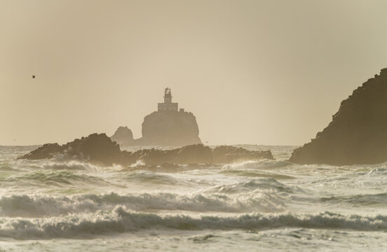 Tillamook Rock Lighthouse stands offshore surrounded by heavy surf and sea mist near Indian Beach along the Oregon coast.