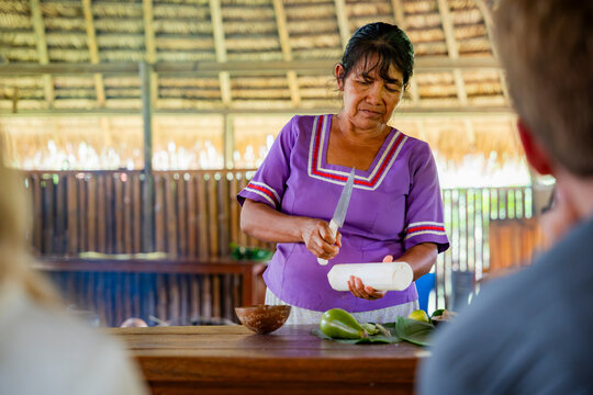 Amazonian woman prepare traditional cassava food for tourists