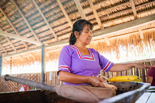 Amazonian woman prepare ancestral food in traditional kitchen