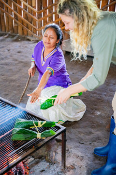 Amazonian women prepare ancestral maito over an open fire
