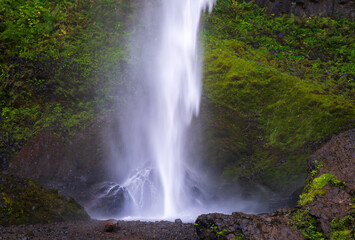 Water cascades into the rocky pool at the base of Lower Latourell Falls within Guy W. Talbot State Park in Oregon. © steheap