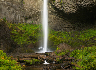 Water cascades into the rocky pool at the base of Lower Latourell Falls within Guy W. Talbot State Park in Oregon. © steheap