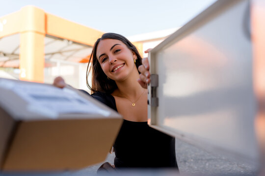 Woman collect parcel from gas station locker
