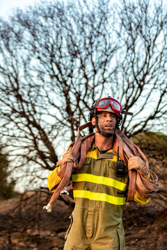 Firefighter carry hose in forest after emergency response