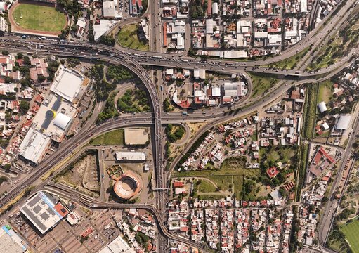 Santiago de Queretaro, Queretaro, Mexico - 19 September 2026: Aerial view of the 5 de Febrero highway interchange featuring complex road networks and surrounding urban infrastructure.