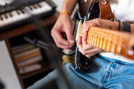 Musician play electric guitar in home recording studio