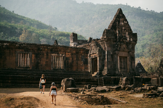 Travelers explore ancient Wat Phu temple ruins in Laos