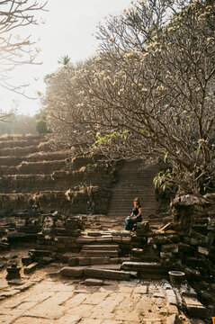 Traveler at Wat Phu Champasak temple ruins in Laos