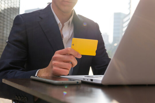 Businessman shop online with Bitcoin credit card in city