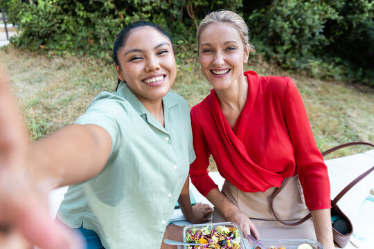 Business women take selfie during outdoor lunch break