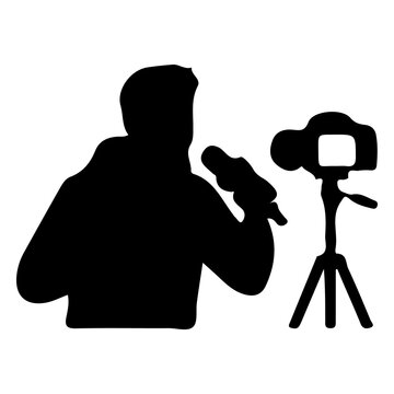 Journalist with microphone reporting news and cameraman filming on tripod at event.