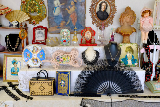 Antique trinkets, portrait, and jewelry shelf display