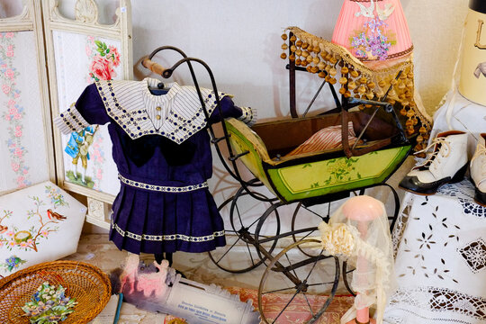 Antique child's dress and vintage baby carriage 