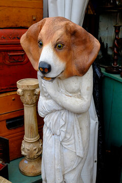 Quirky dog head mask on a statue figure 