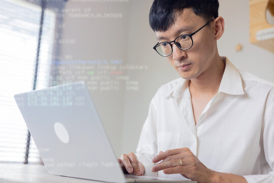 close up computer programmer man typing configuration on keyboard at laptop for input coding language to software for fix bug and defect of system in data center room , engineering and technology