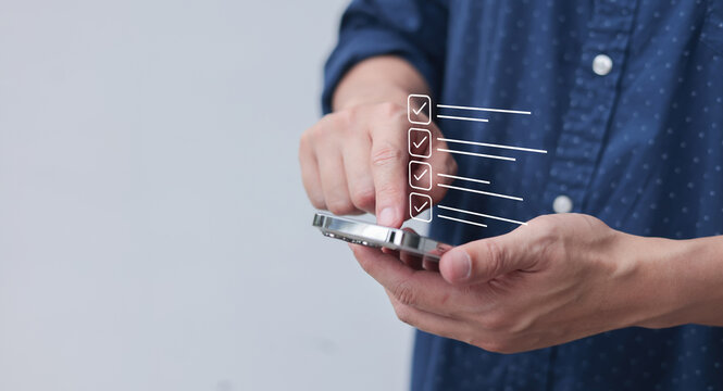 close up man hand hold smartphone and use banking application to check mark on consent condition form for business and lifestyle concept