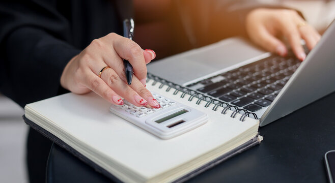 close up manager man hand press on calculator to calculate about commission rate form company's project after deal with client in office room for business lifestyle concept