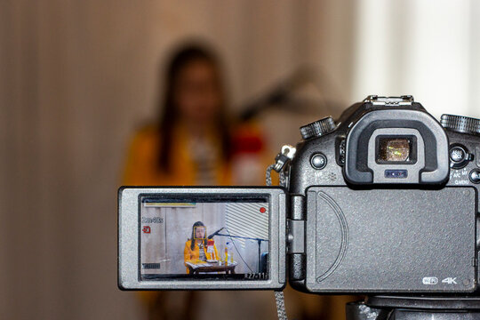 process of shooting on a digital camera on  tripod, interviews of women, folding screen, recording, sitting at table, 